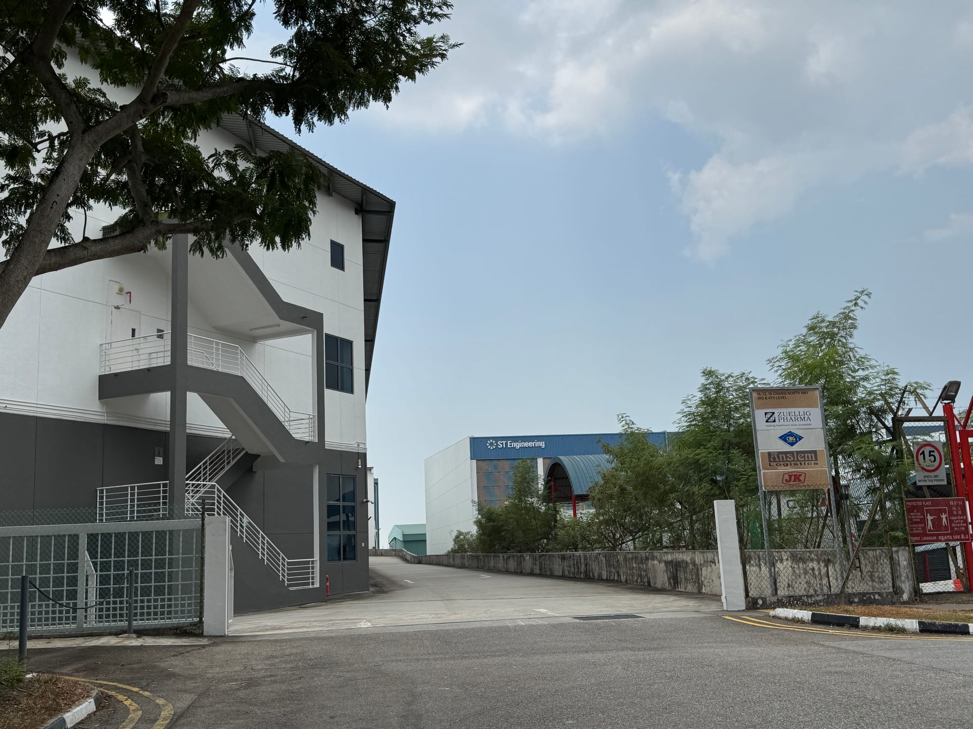 Driveway and external staircase at 12 Changi North Way, with the neighbouring ST Engineering building beyond
