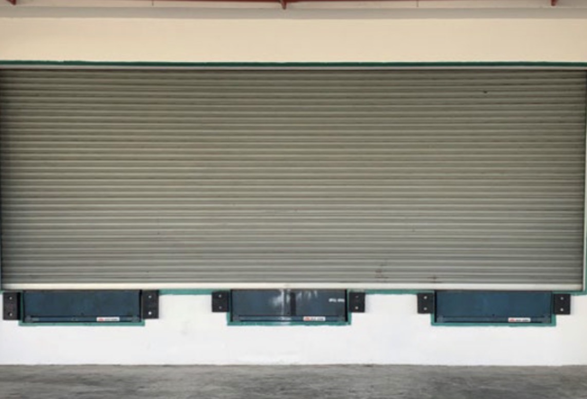 Close-up of loading dock levellers and roller shutter door at the dedicated loading platform