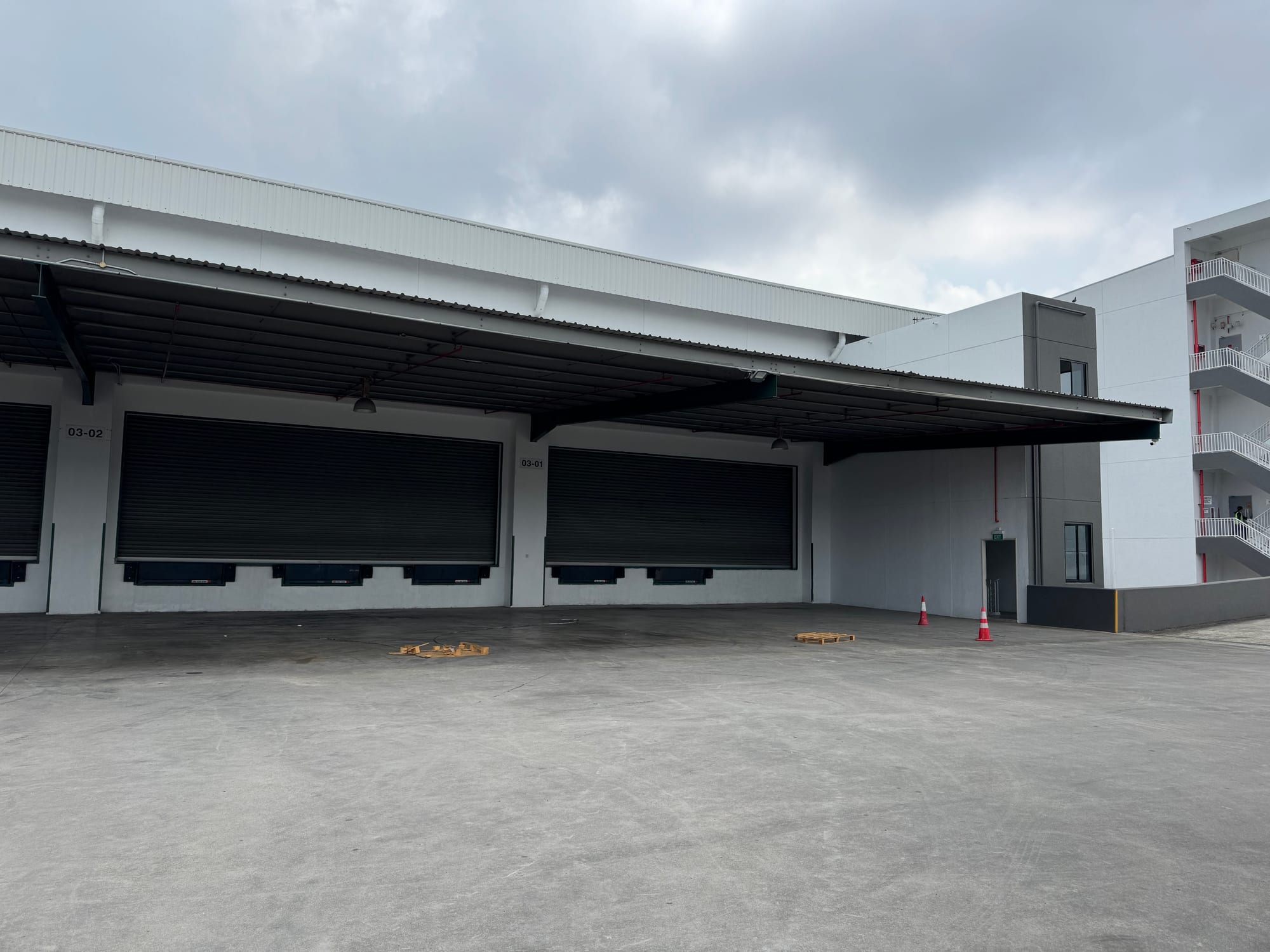 Loading platform with roller shutter doors and dock levellers at bays 03-01 and 03-02