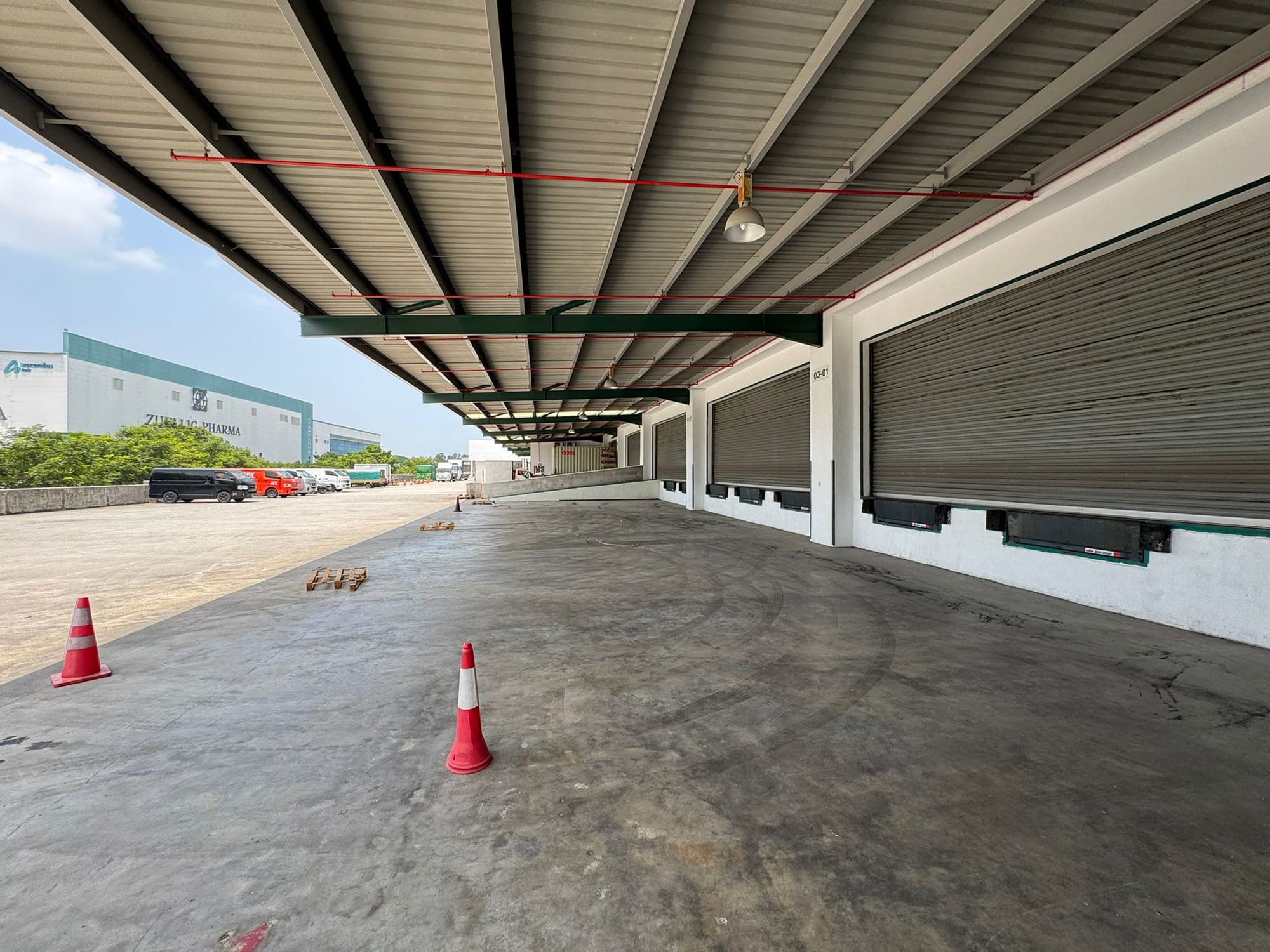 Unloading bay 03-01 at 12 Changi North Way, with the covered loading platform and neighbouring Zuellig Pharma building beyond