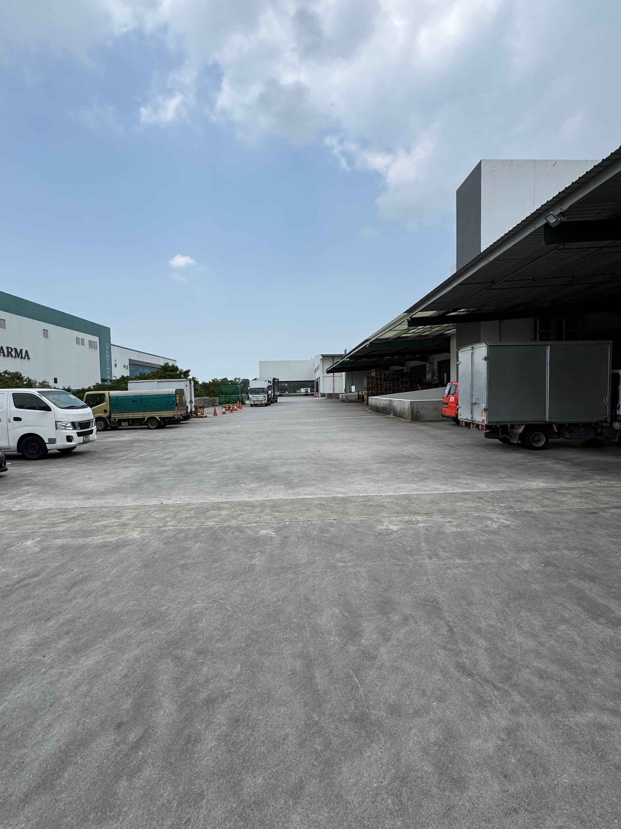 Covered loading yard at 12 Changi North Way with delivery trucks and vans
