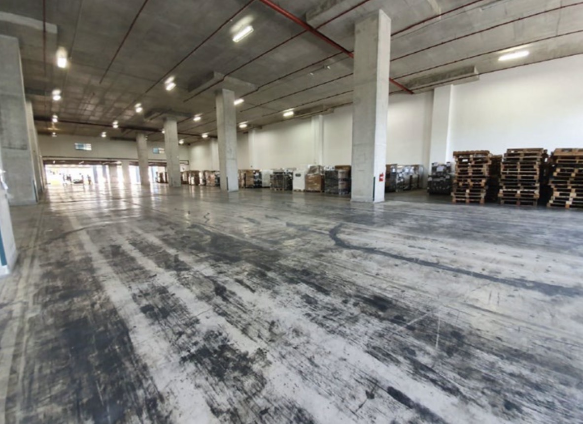 Warehouse interior at 12 Changi North Way with high concrete ceiling, columns and loading platform